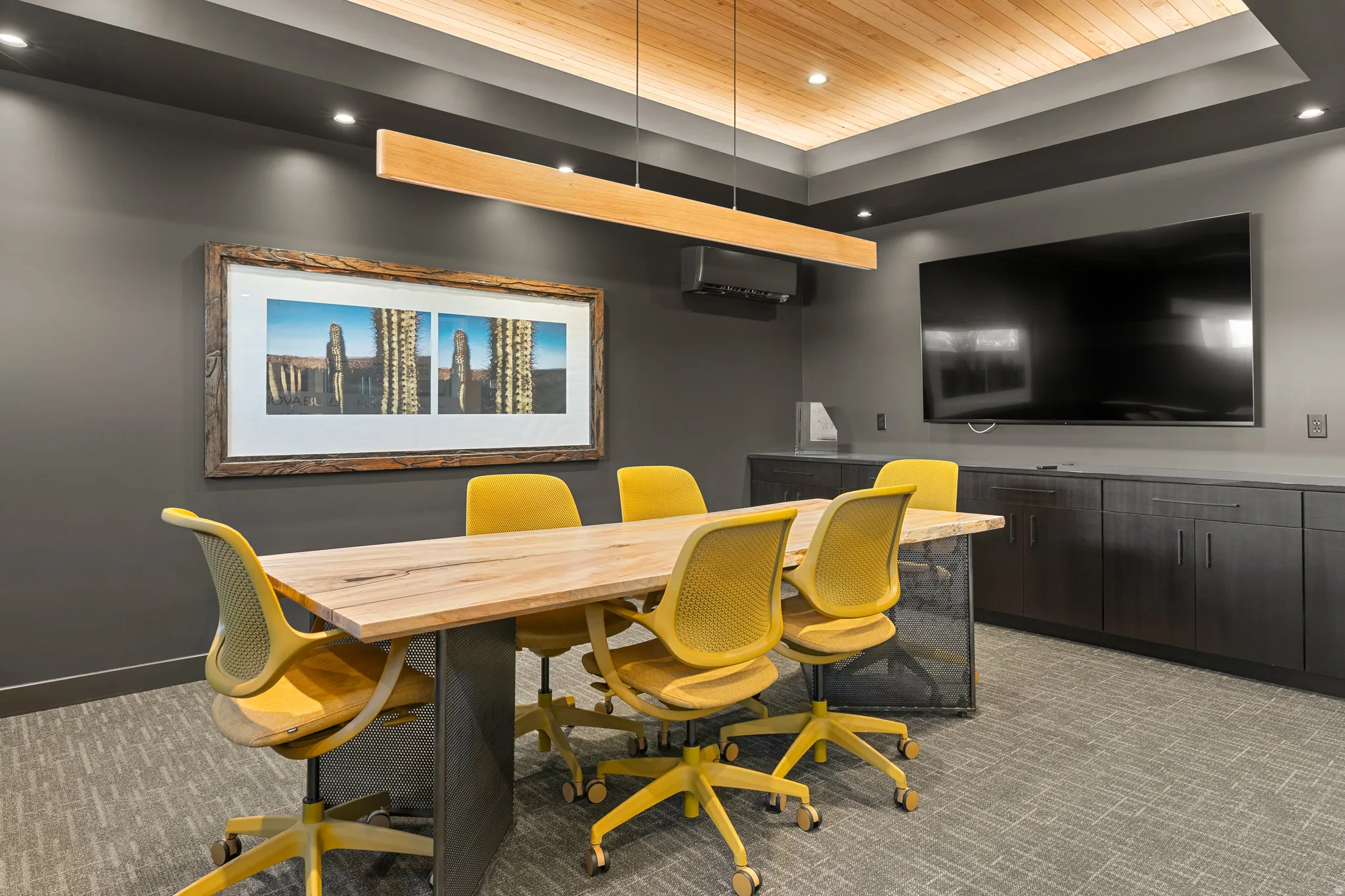 Meeting space featuring a wood-finish ceiling, recessed lighting, and a linear pendant light fixture