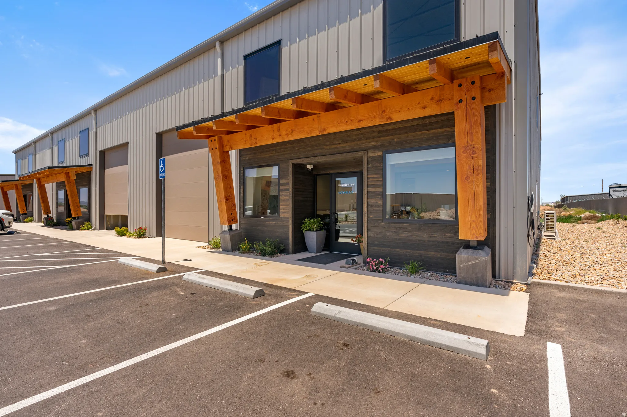 Modern commercial building featuring corrugated metal siding and a wood-accented entryway