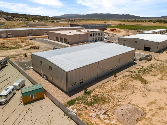 Large industrial building featuring a metal roof and corrugated metal siding