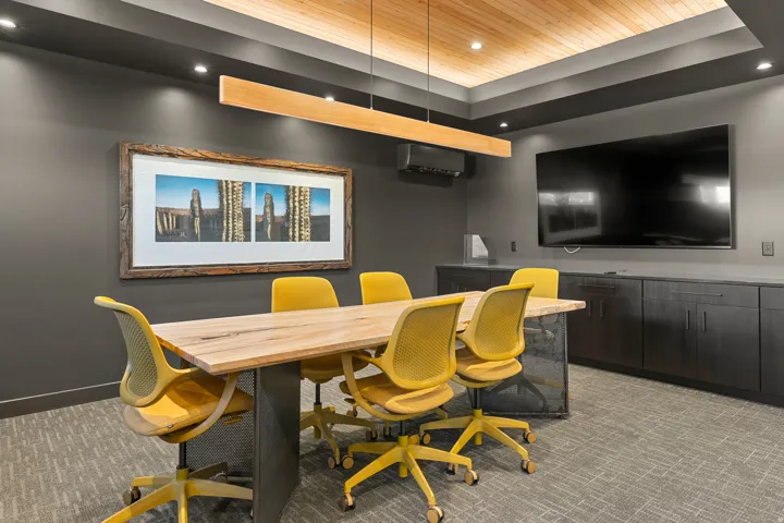 Meeting space featuring a wood-finish ceiling, recessed lighting, and a linear pendant light fixture