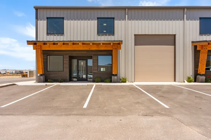 Commercial building with metal siding and a wood-beam portico