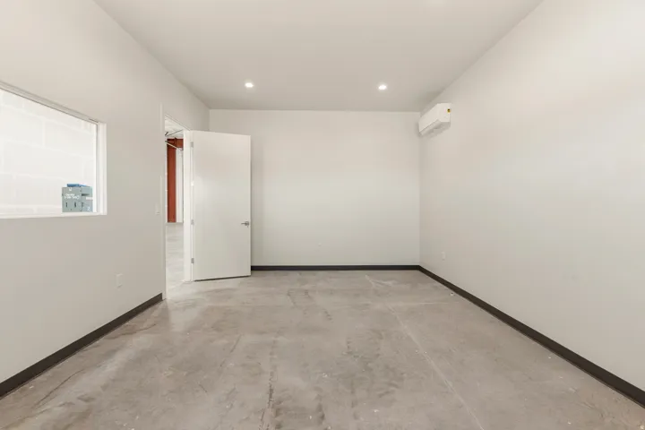 Interior room featuring concrete flooring and white painted walls