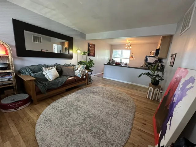Wood-finish flooring throughout, open-concept design, built-in breakfast bar, recessed lighting