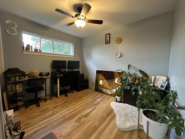 Hardwood flooring, recessed window, ceiling fan with integrated lighting, light gray wall finish