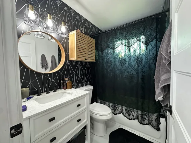 White vanity with an integrated sink and matte black faucet