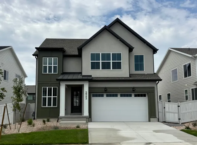 Two-story exterior with a two-car garage, covered entry, and black trim windows