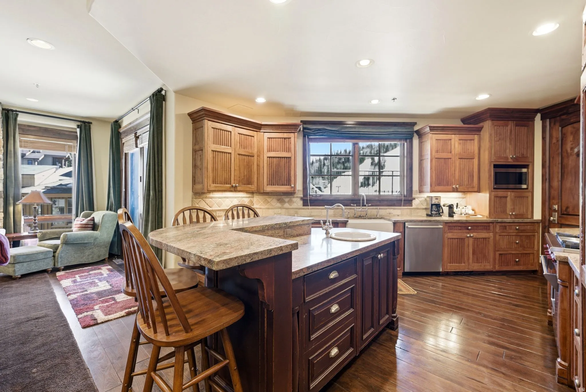 Kitchen featuring wood-finish flooring, recessed lighting, and a window with mountain scenery