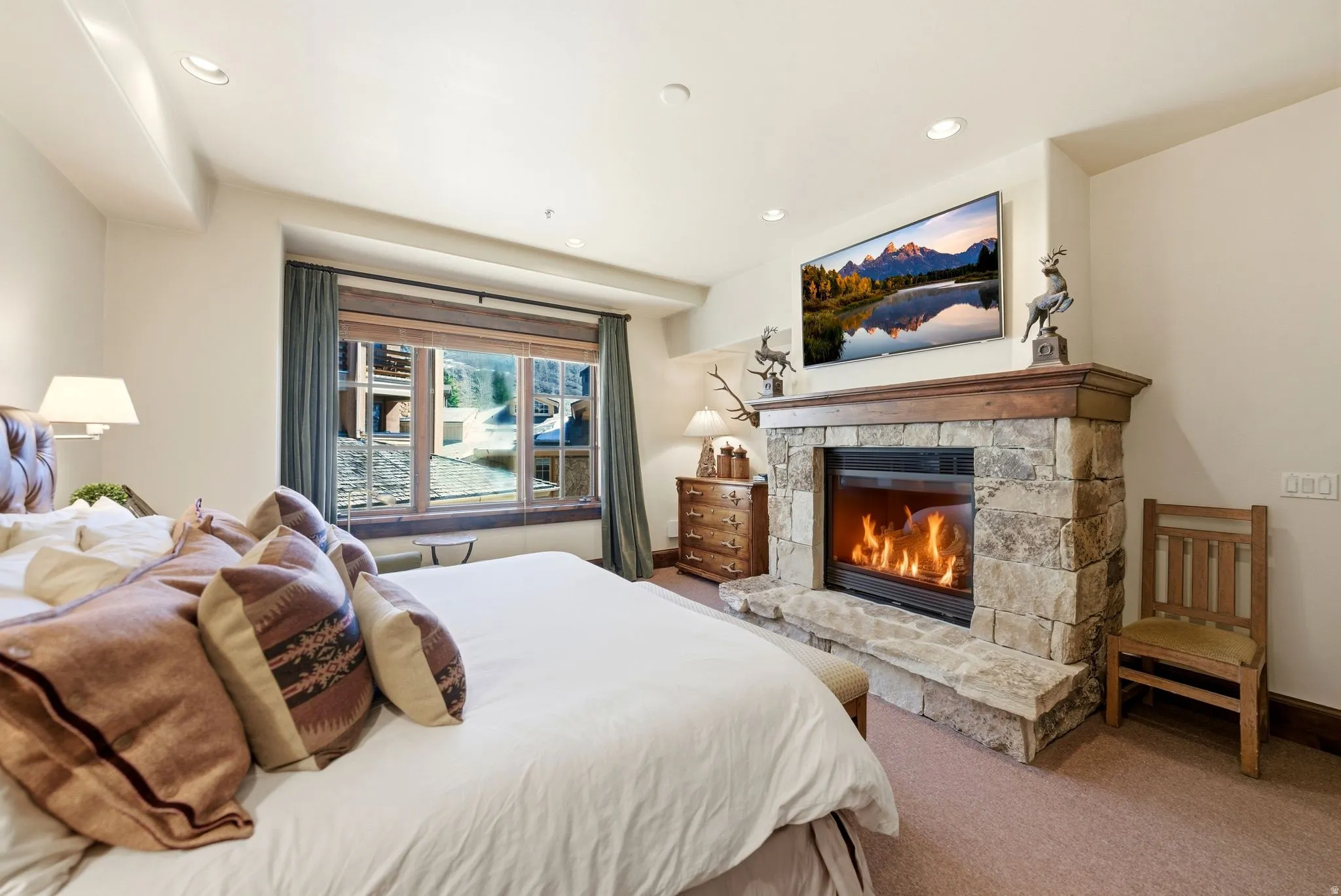 Stone-clad fireplace with a wood mantle