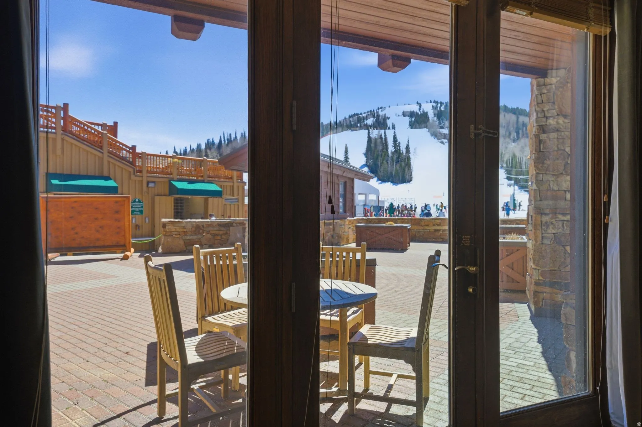 Glass paneled French doors providing access to a brick paver patio