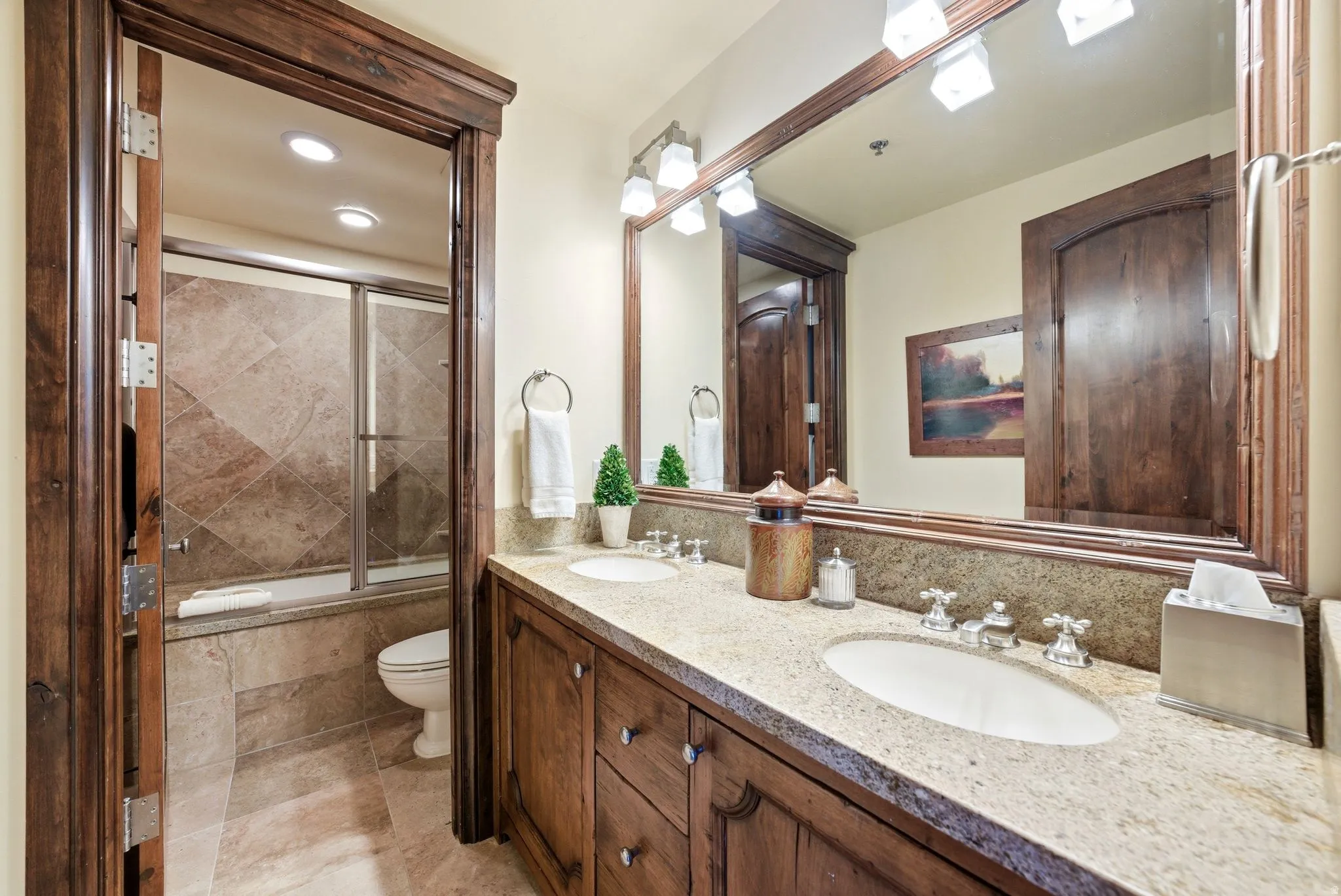 Dual vanity with light-toned countertop, integrated sinks, and polished chrome faucets