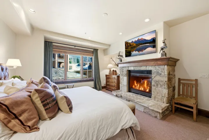 Stone-clad fireplace with a wood mantle