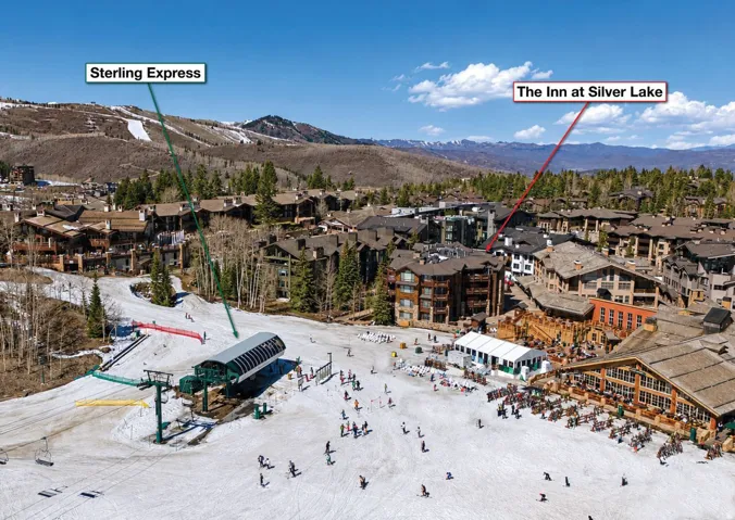 Ski-in/ski-out village setting featuring a chairlift, multiple multi-story resort buildings, and mountain vistas