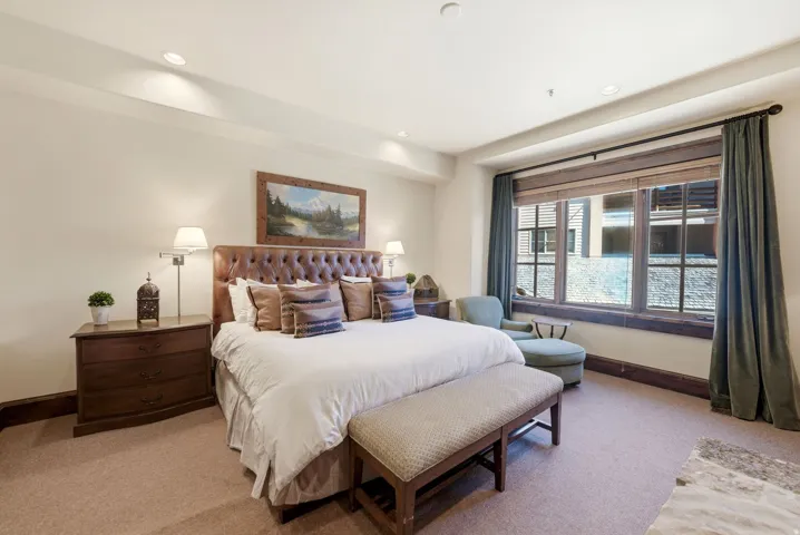 Carpeted bedroom featuring a large window with wooden blinds, recessed lighting, and crown molding