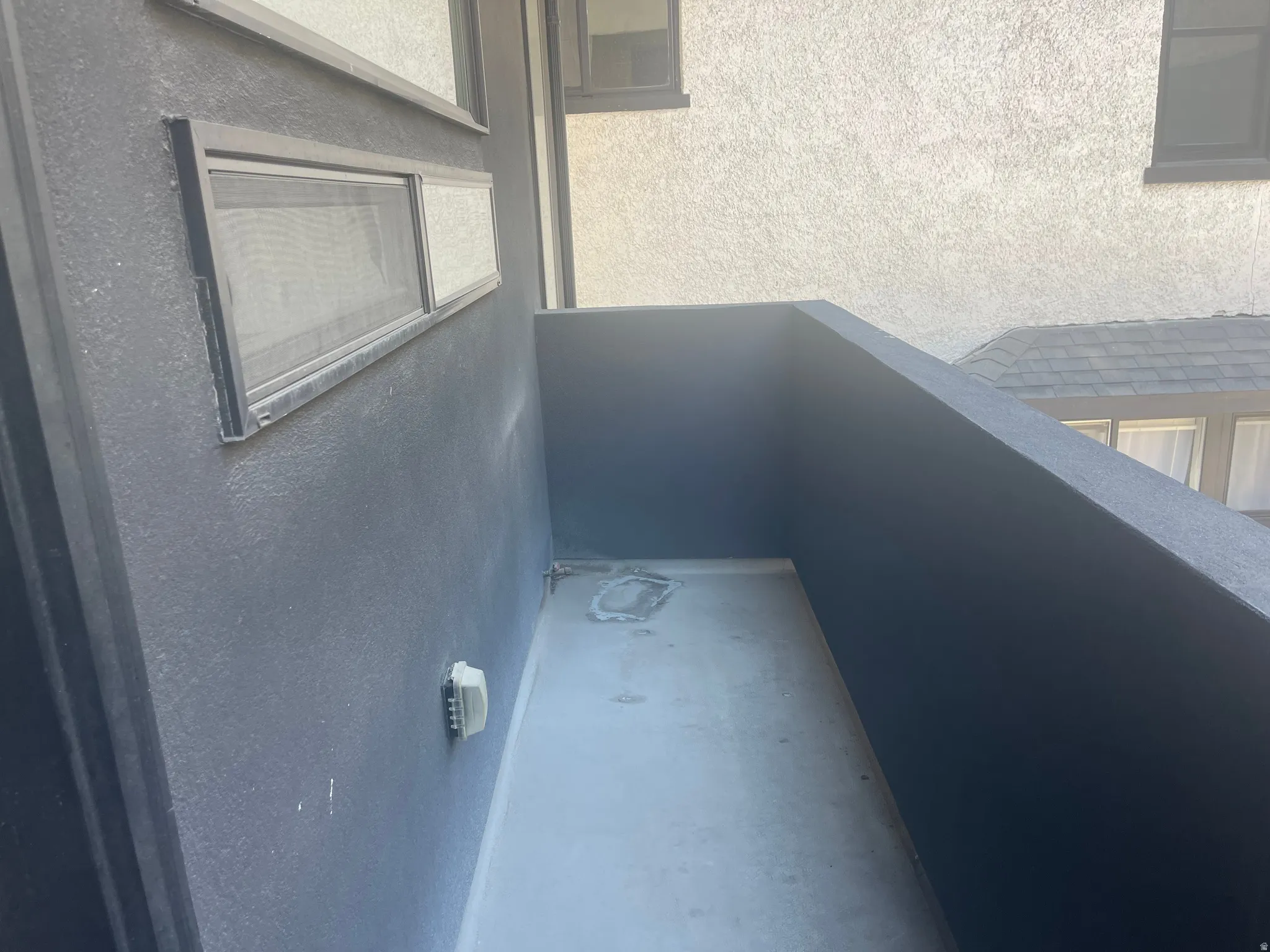 West facing Private outdoor balcony with textured walls and a durable floor surface
