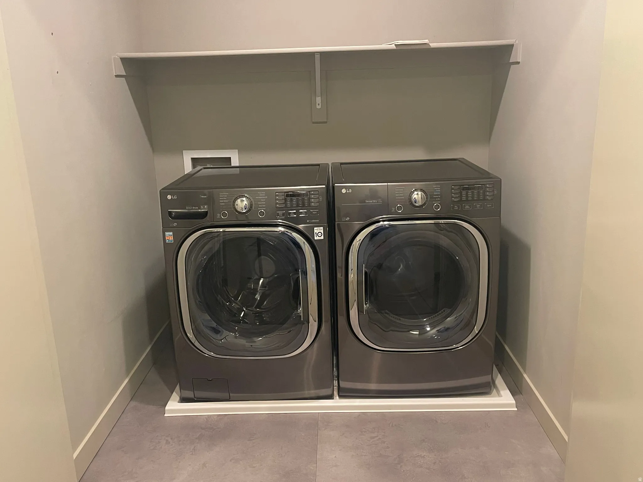 Dedicated laundry area featuring a shelf, vent, and space for a full-size washer and dryer