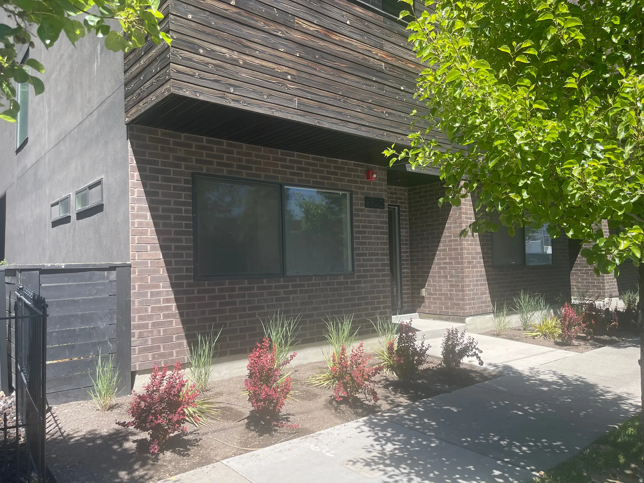 Contemporary exterior featuring brick and wood-panel accents