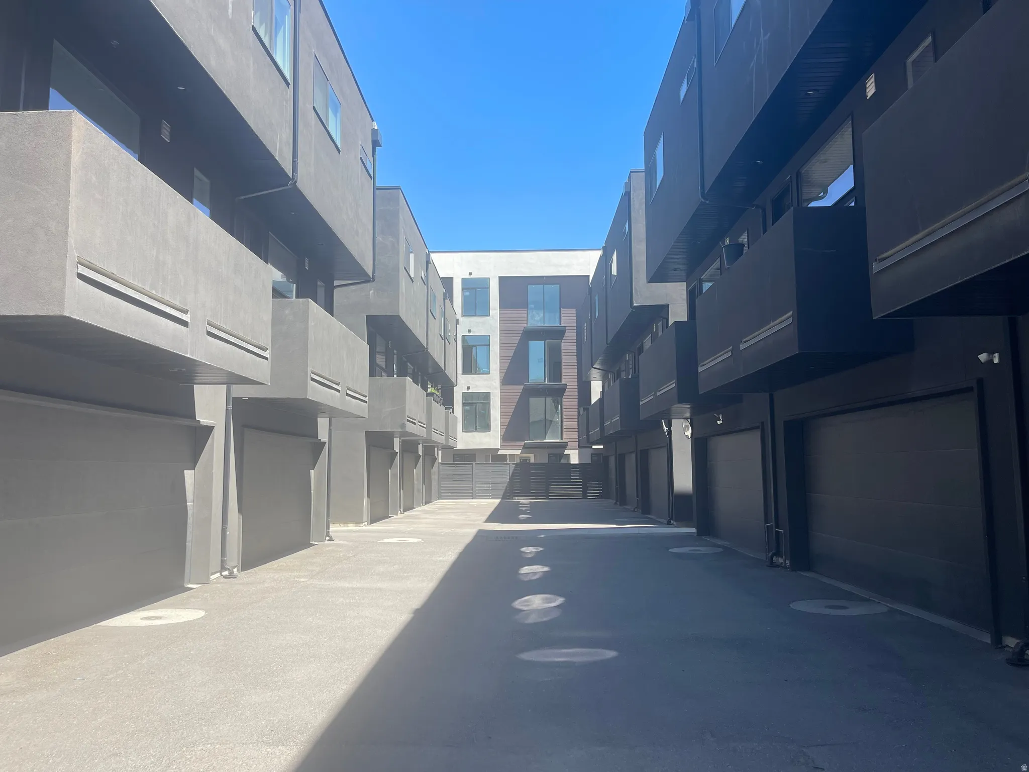 Gated entrance Modern architectural exterior with private balconies and integrated garages