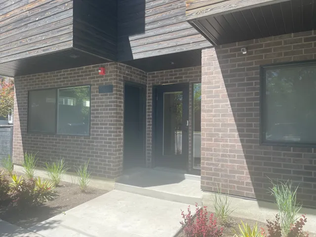 Modern facade featuring brick cladding and horizontal wood-finish siding
