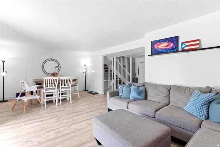 Bright open-concept living space with light-tone wood-finish flooring