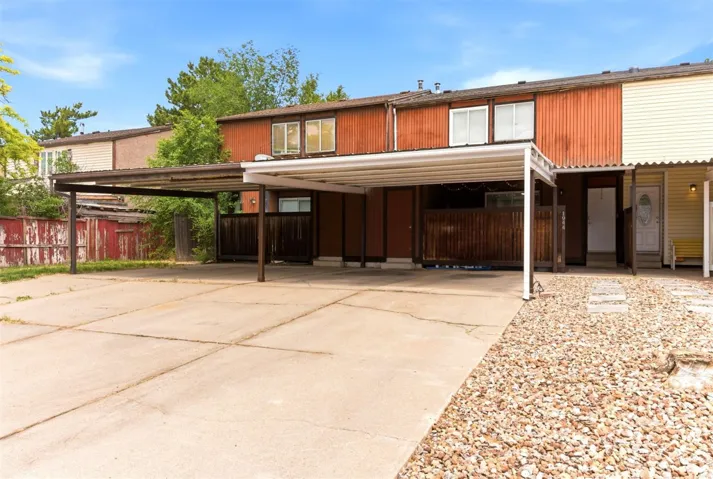 Concrete driveway with two attached carports providing covered parking
