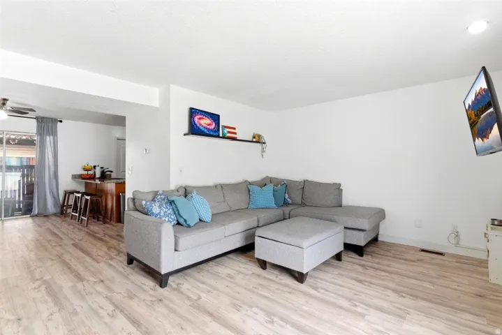Bright living area featuring wood-finish flooring and white walls