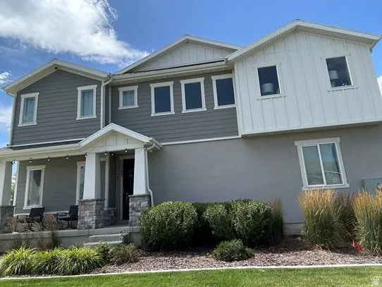 Contemporary exterior with mixed gray siding and stucco finishes