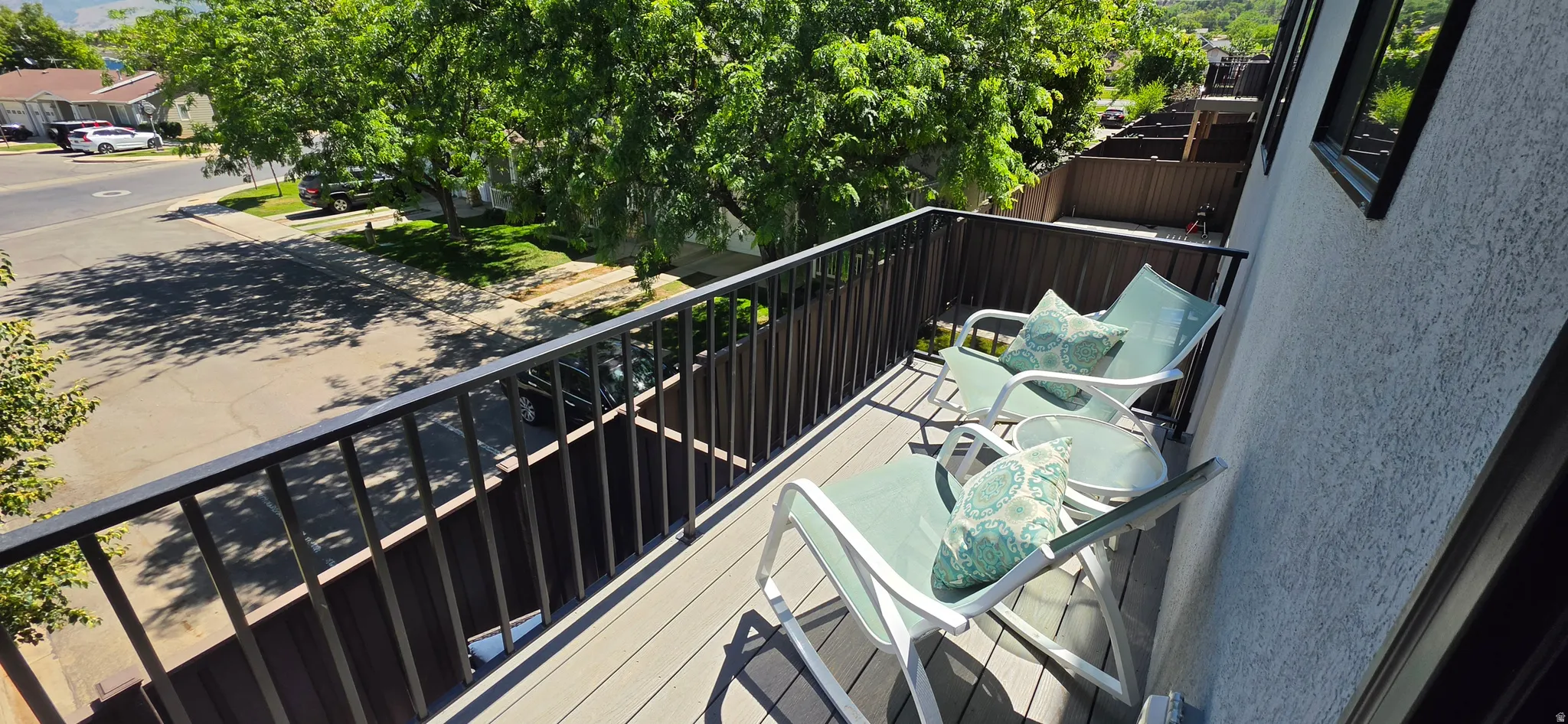 Private balcony featuring composite decking and black metal railings