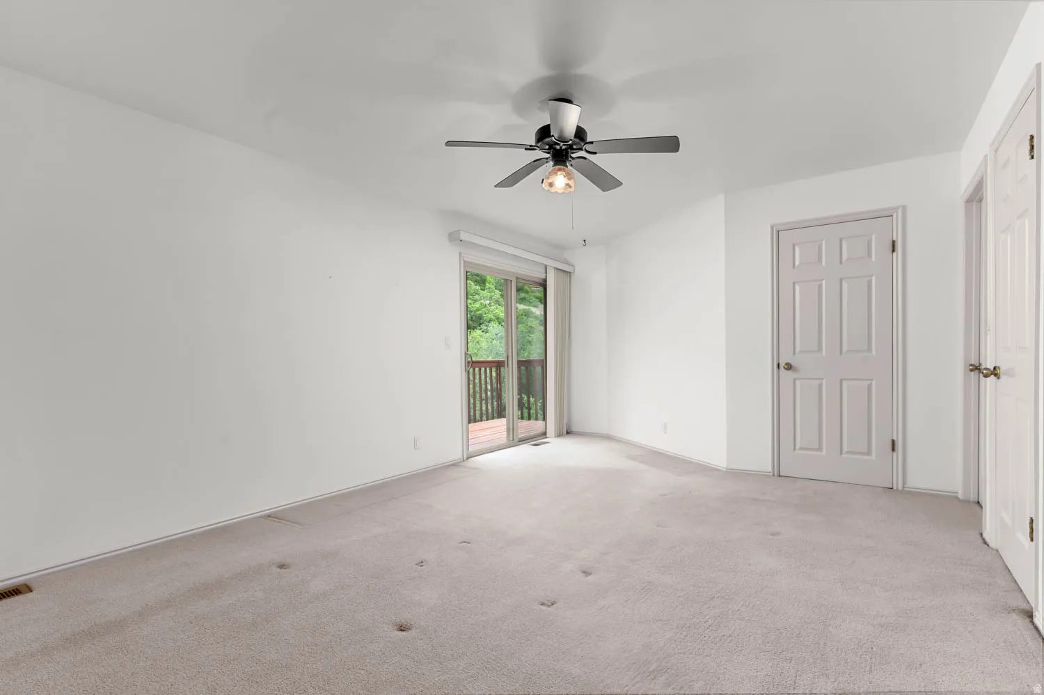 Primary bedroom with balcony- unstaged