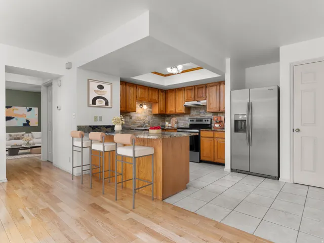 Kitchen featuring granite countertops and stainless steel appliances- virtually staged