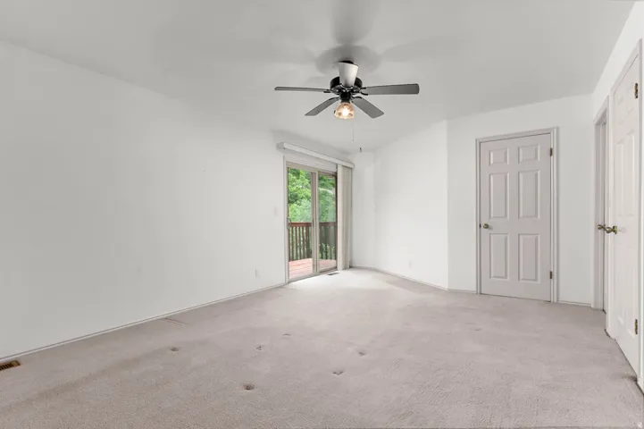 Primary bedroom with balcony- unstaged