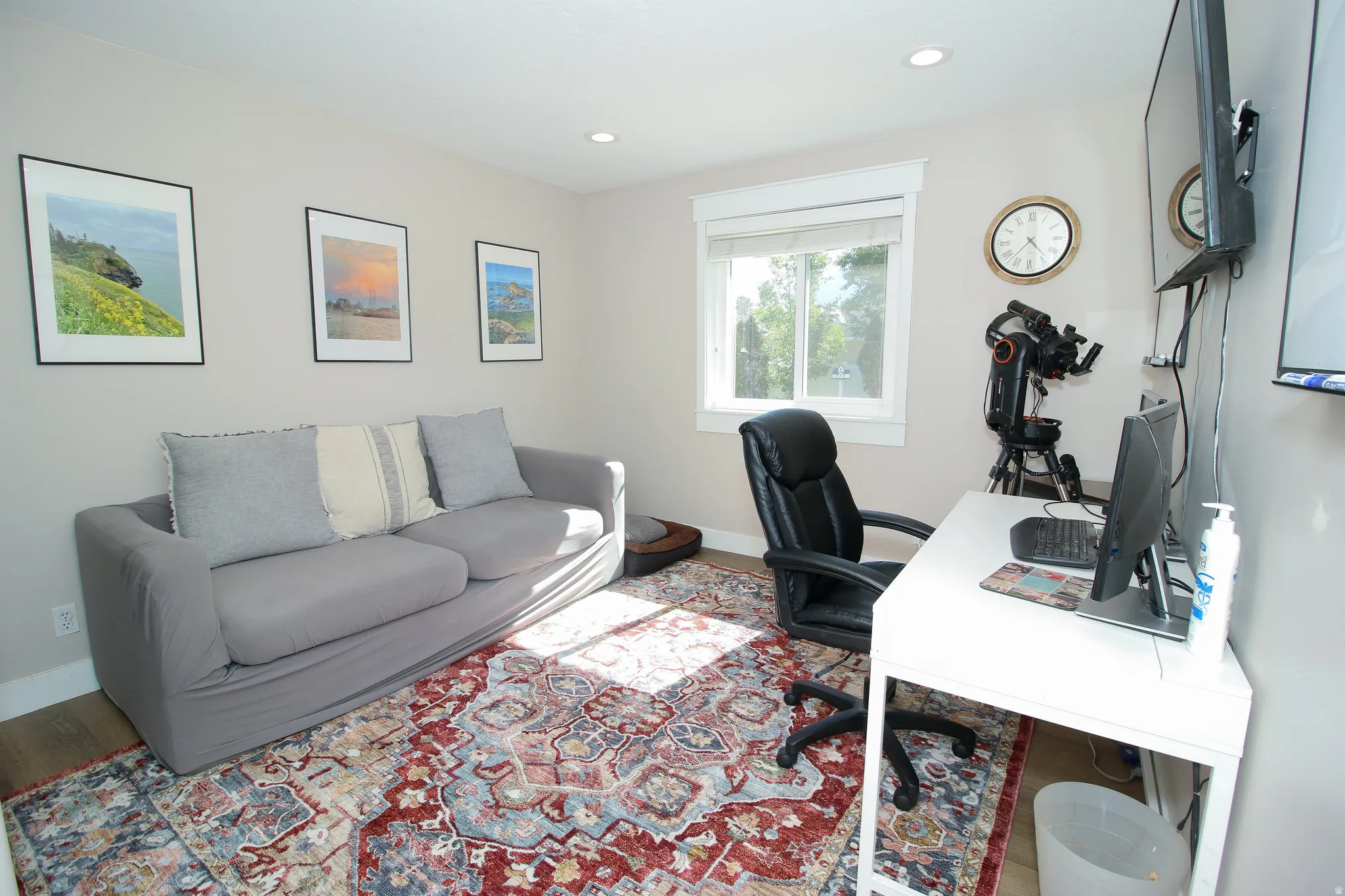 Bright room featuring wood-finish flooring and recessed lighting
