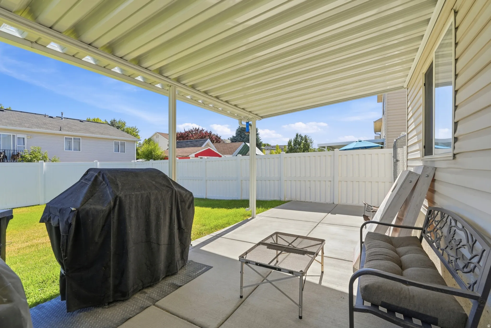 Covered patio area featuring a concrete surface