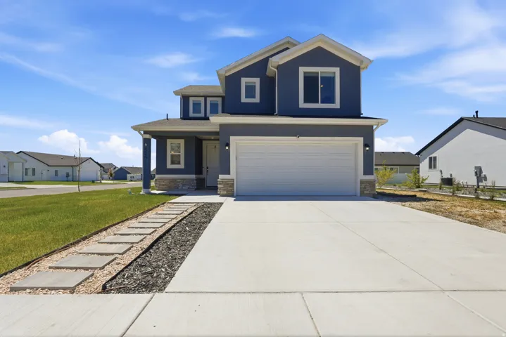 Contemporary two-story residence featuring a blue exterior and white trim accents