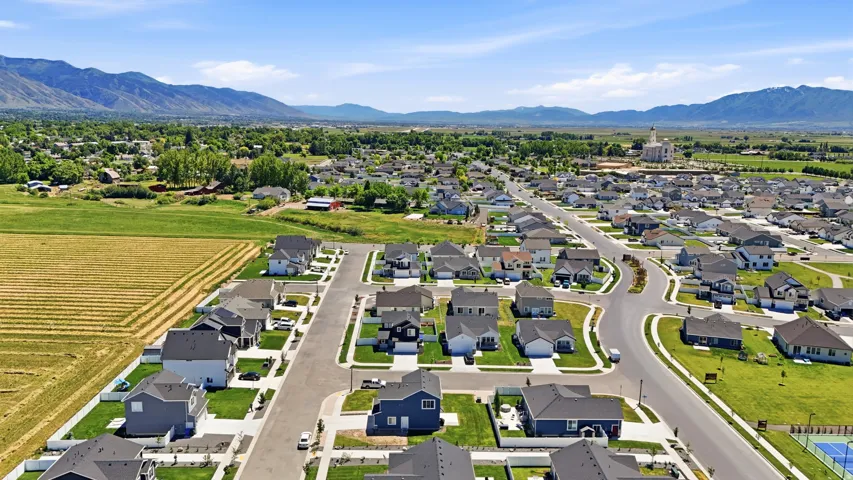 Expansive residential community with newly constructed properties, paved streets, and manicured landscaping