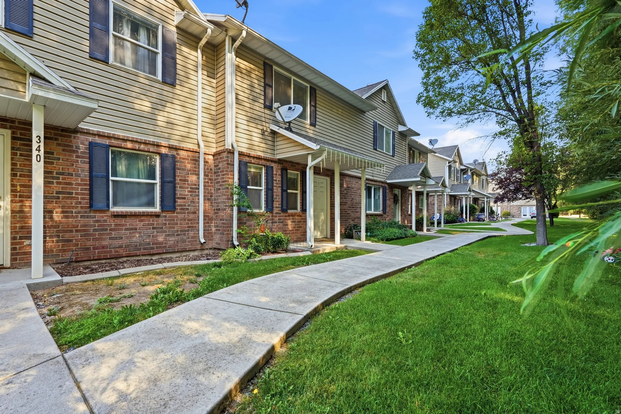 Townhome exterior featuring brick and siding construction