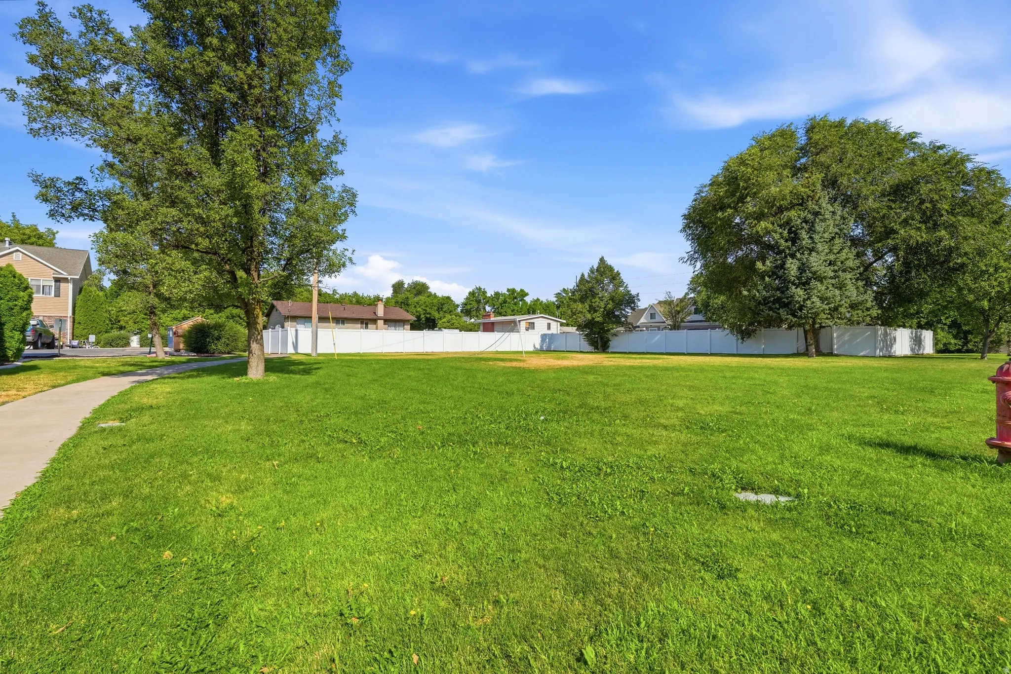 Expansive green space featuring a level lawn