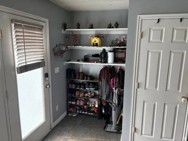 Built-in shelving and coat hooks offer organized storage