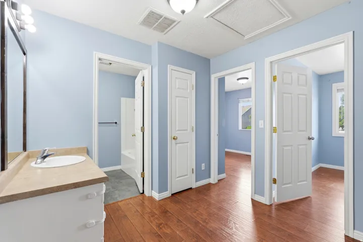 Bathroom vanity with light countertop and white sink basin