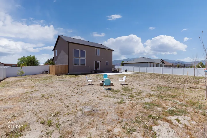 Expansive backyard area with a large concrete patio