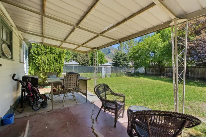 Covered patio space featuring a concrete slab, metal frame, and a solid roof