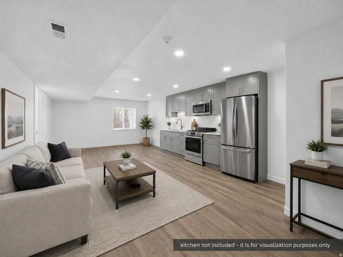 Open-concept living area featuring wood-finish flooring, recessed lighting, and white walls