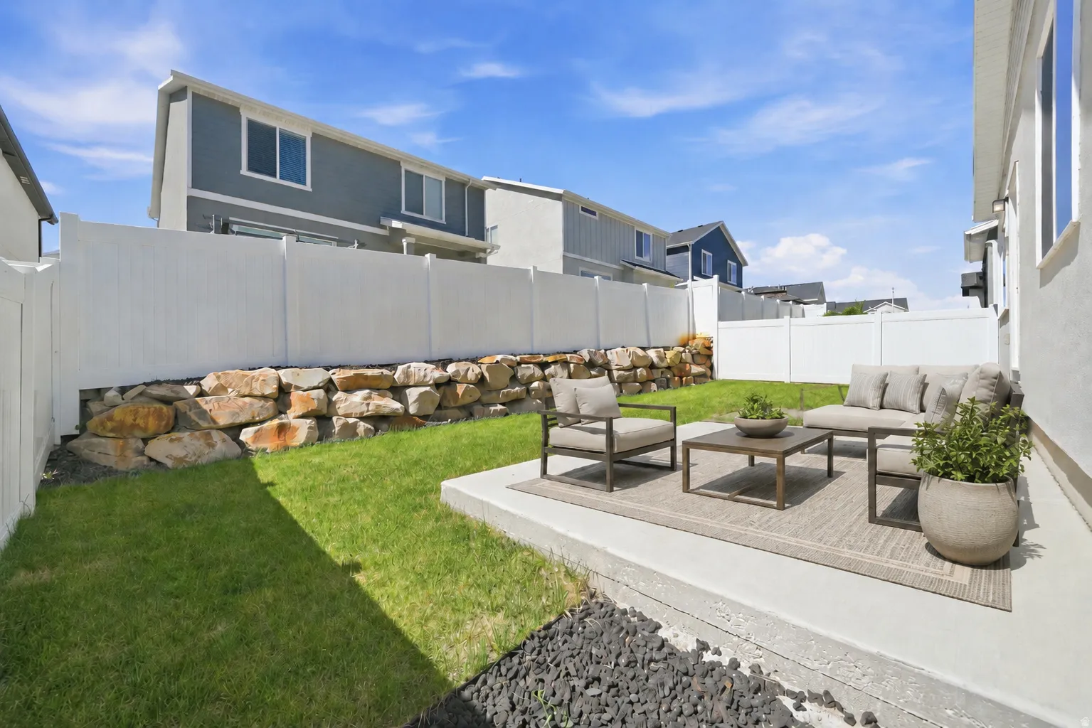 Exterior concrete patio with direct access to a grassy yard