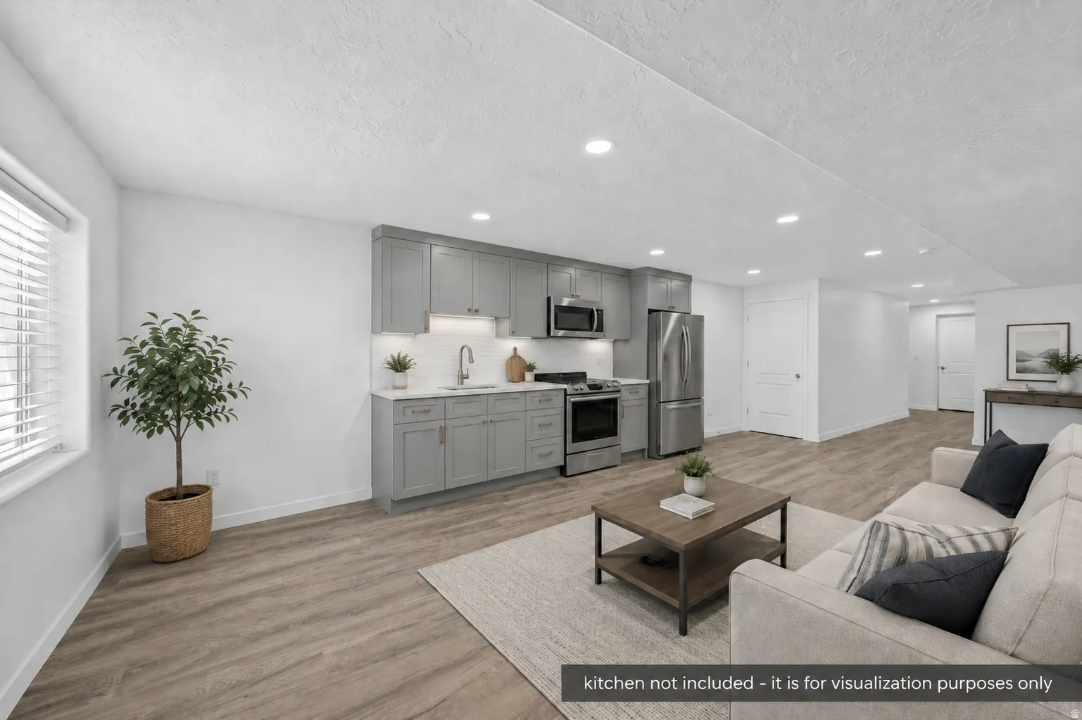 Open-concept living space with wood-finish flooring, recessed lighting, and a window with blinds