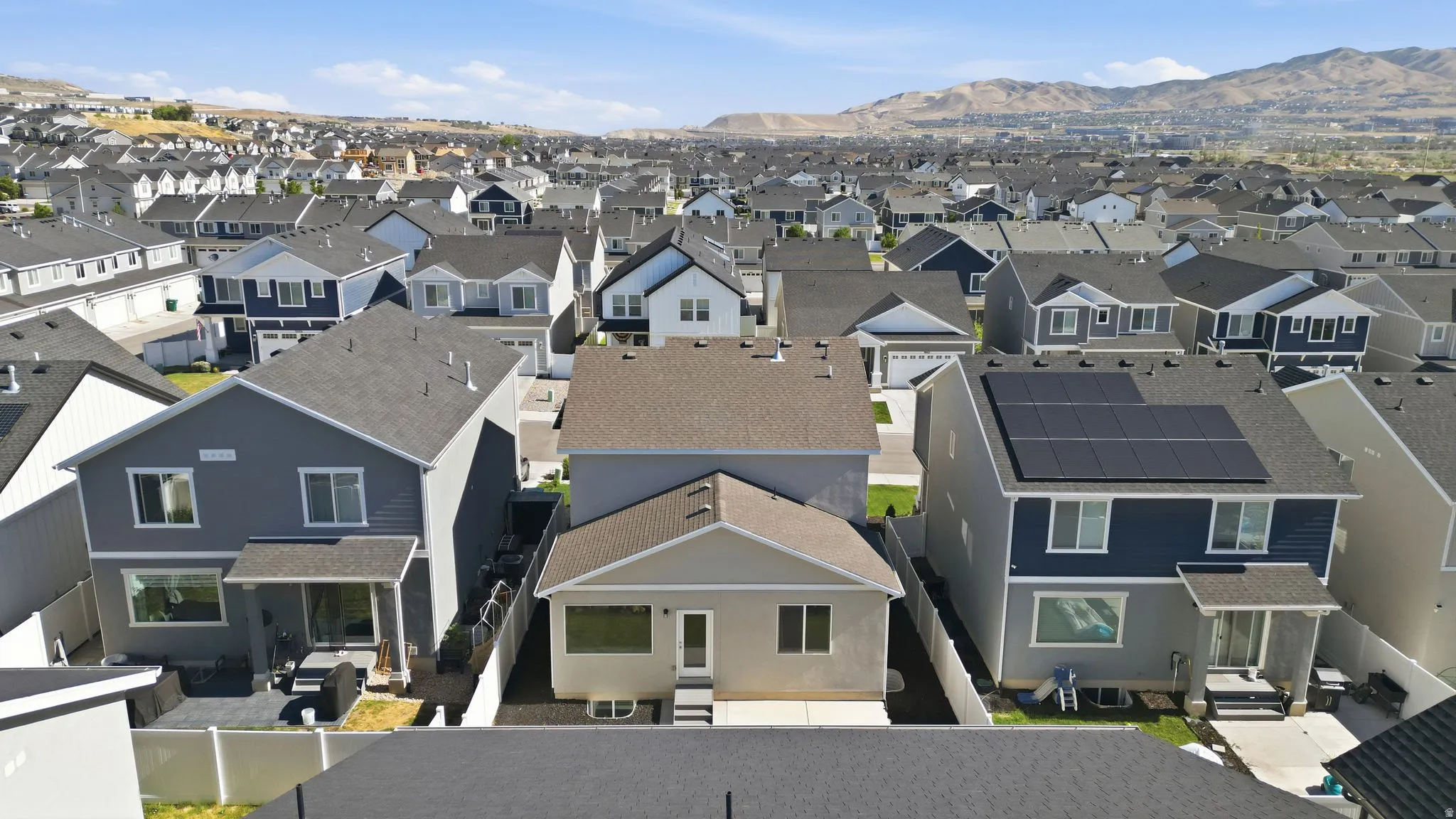 Residential community featuring numerous detached homes with varied exterior finishes and rooflines