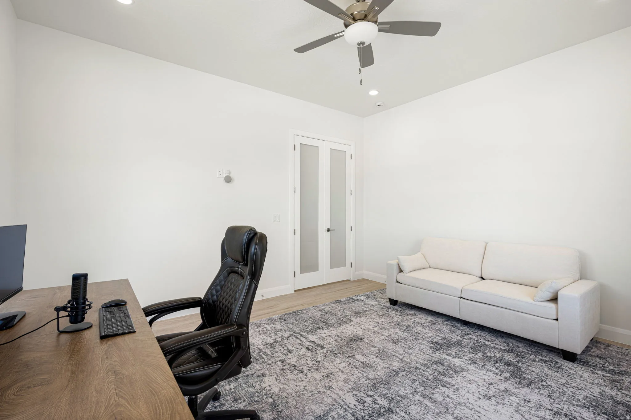 White walls, recessed lighting, and a ceiling fan with integrated light fixture