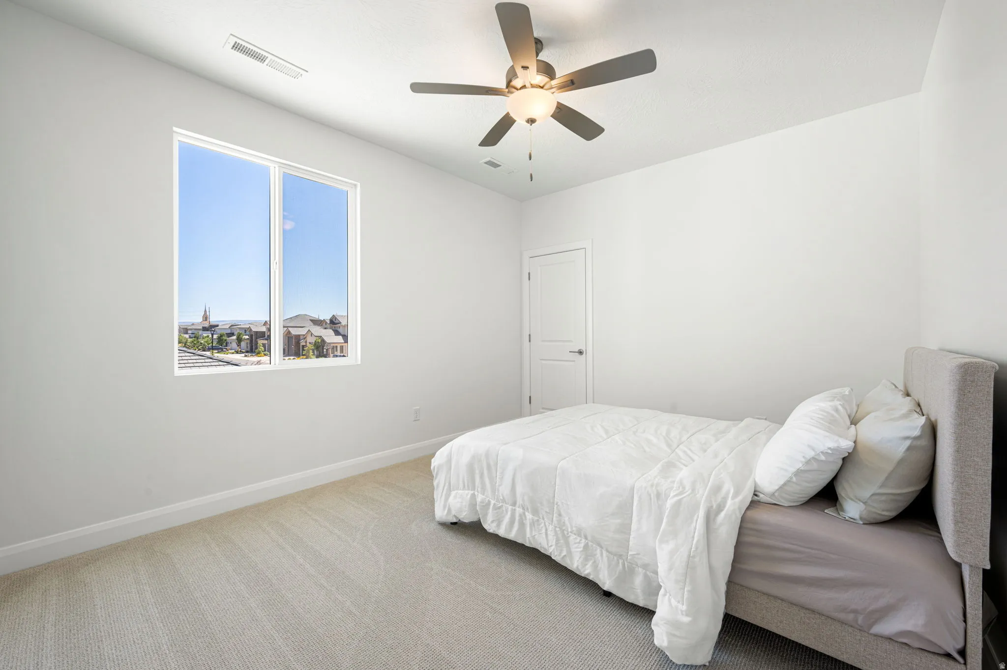 Wall-to-wall carpeting with a bright window