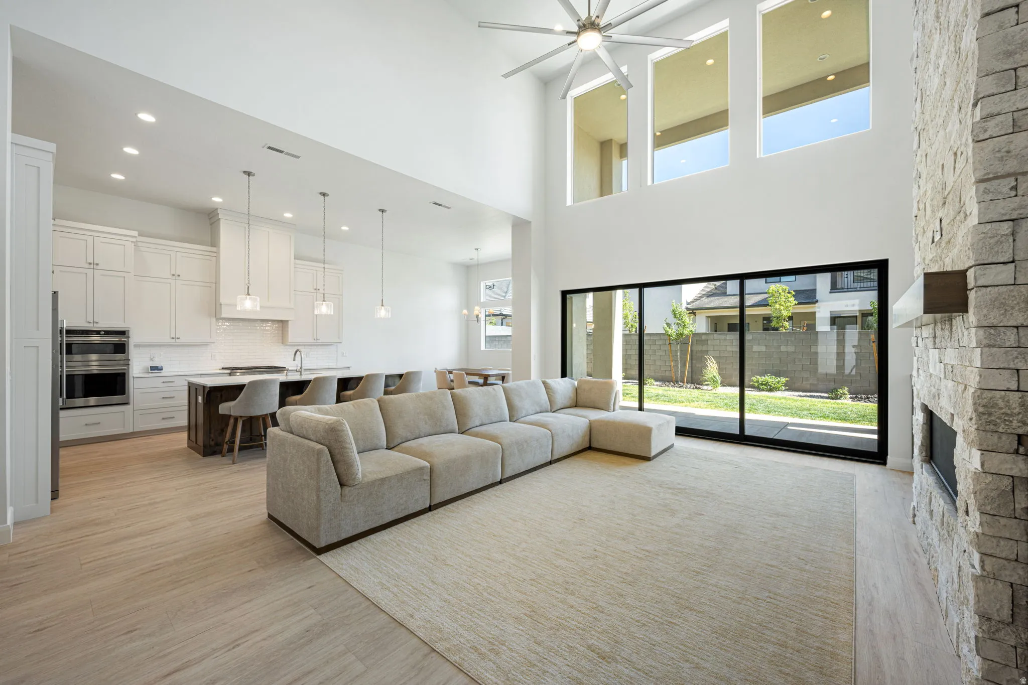 Vaulted ceilings complement the floor-to-ceiling stone fireplace
