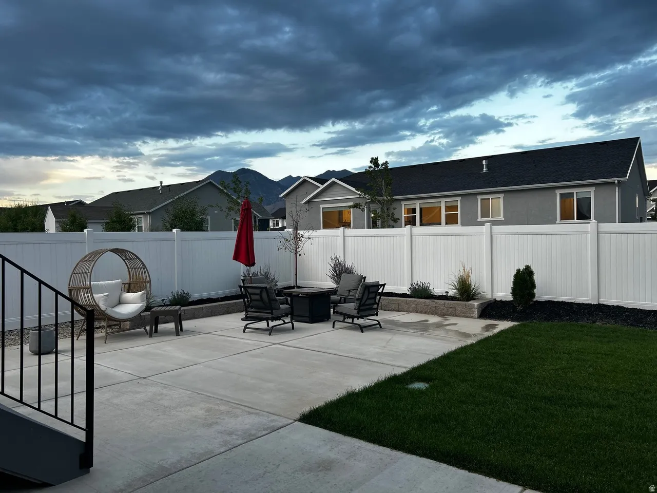 Expansive concrete patio complemented by a manicured lawn