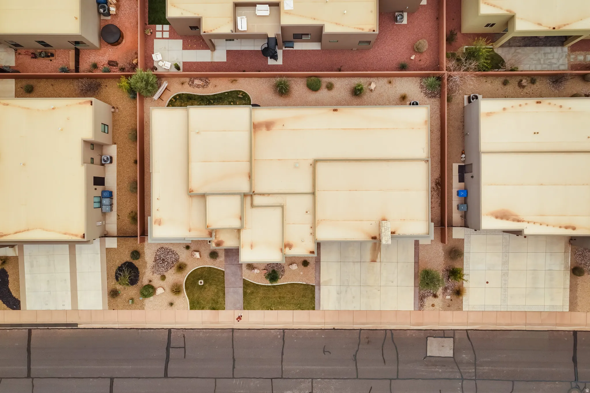 Residential property featuring a rectangular lot, concrete driveway, and front yard with a combination of gravel and small grass areas