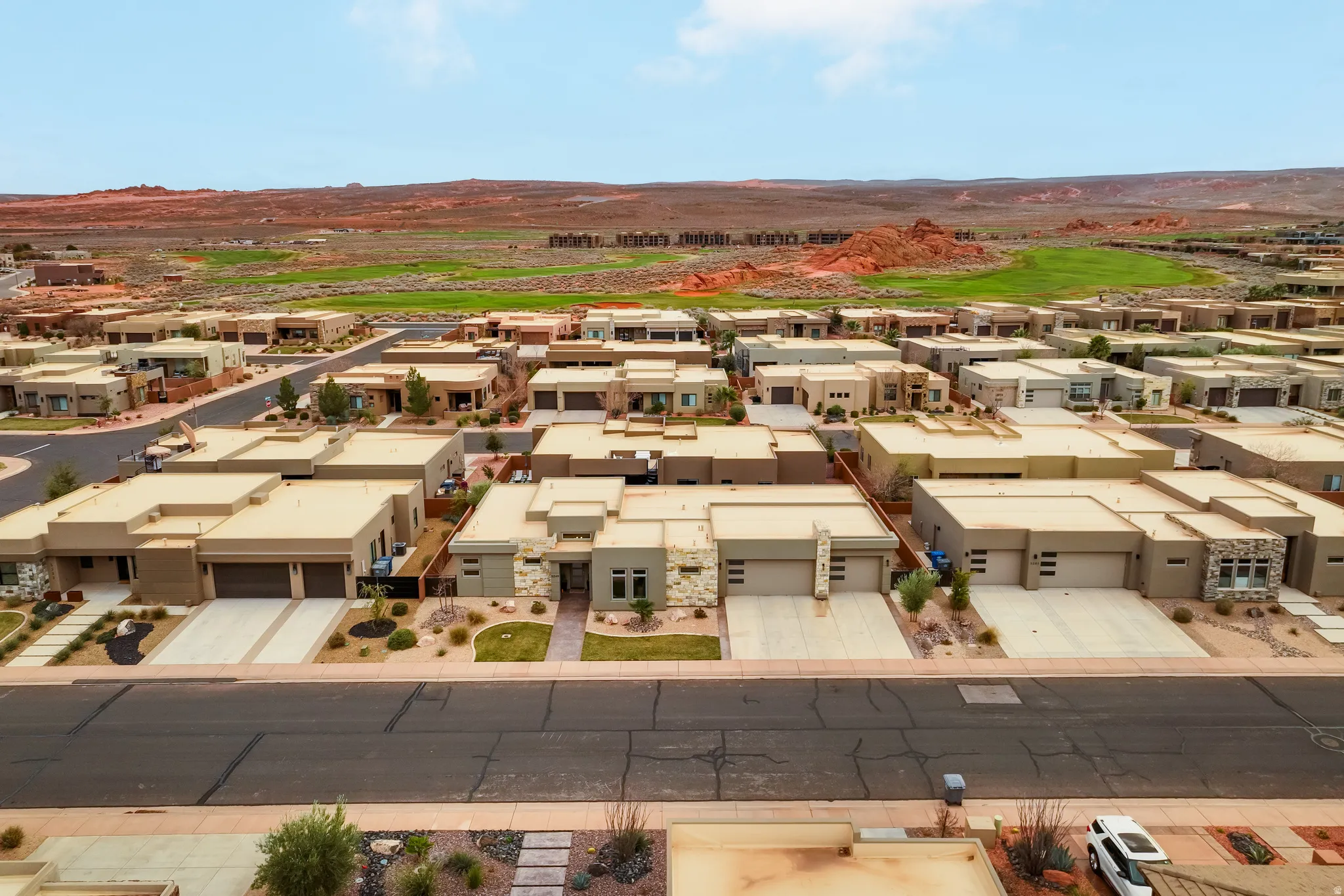 Contemporary residential properties featuring stucco exteriors and attached garages